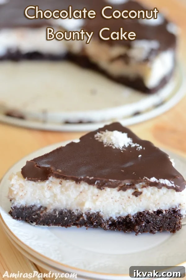 Chocolate Coconut Bounty Cake Recipe – Moist Tropical Layer Cake 2 a piece of bounty cake placed on a white plate on a wooden surface.