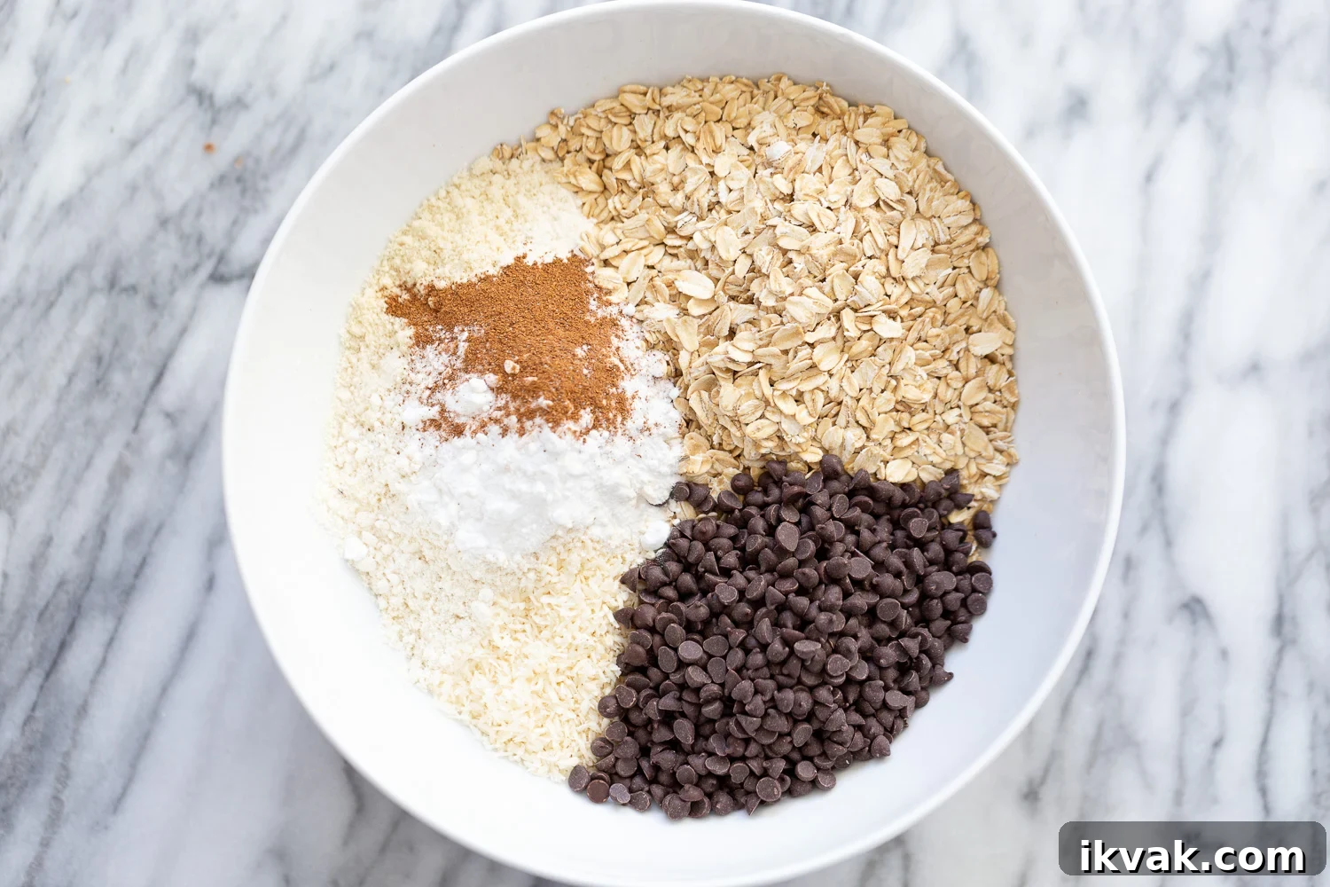 ingredients for making vegan chocolate chip waffles all gathered in a white bowl 