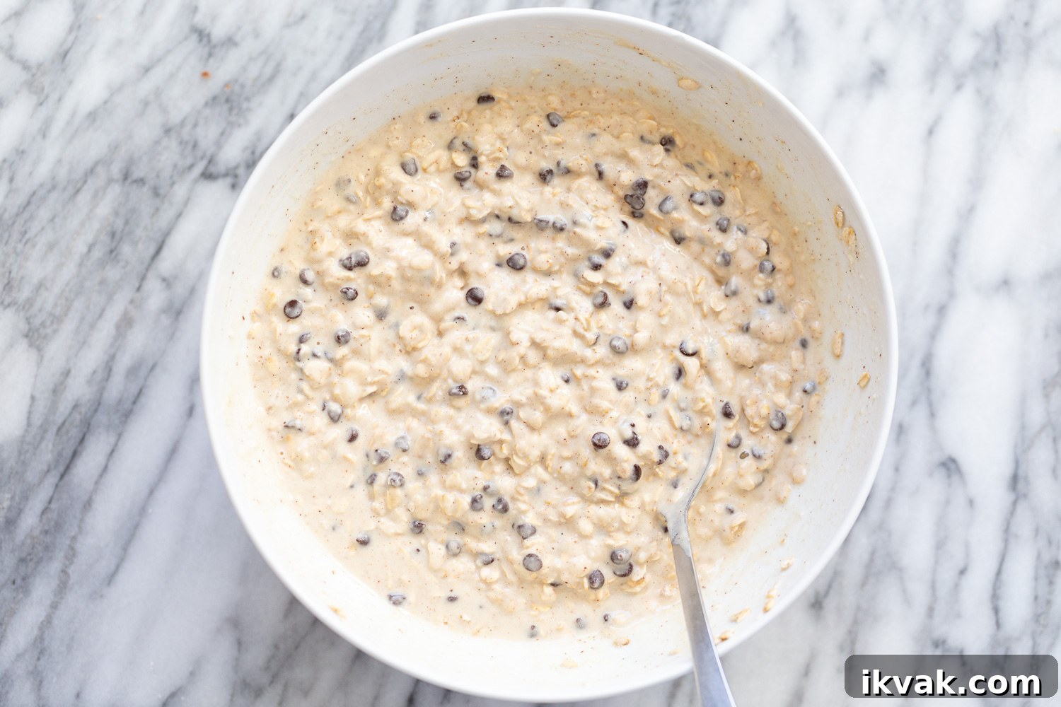 overhead shot of a white bowl with vegan chocolate chip waffle batter 
