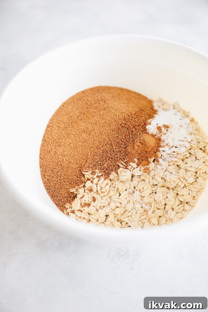 Blueberry Oat Muffins with Oats and Honey Crumble 4 oats, flour, coconut sugar and cinnamon in a large white bowl.