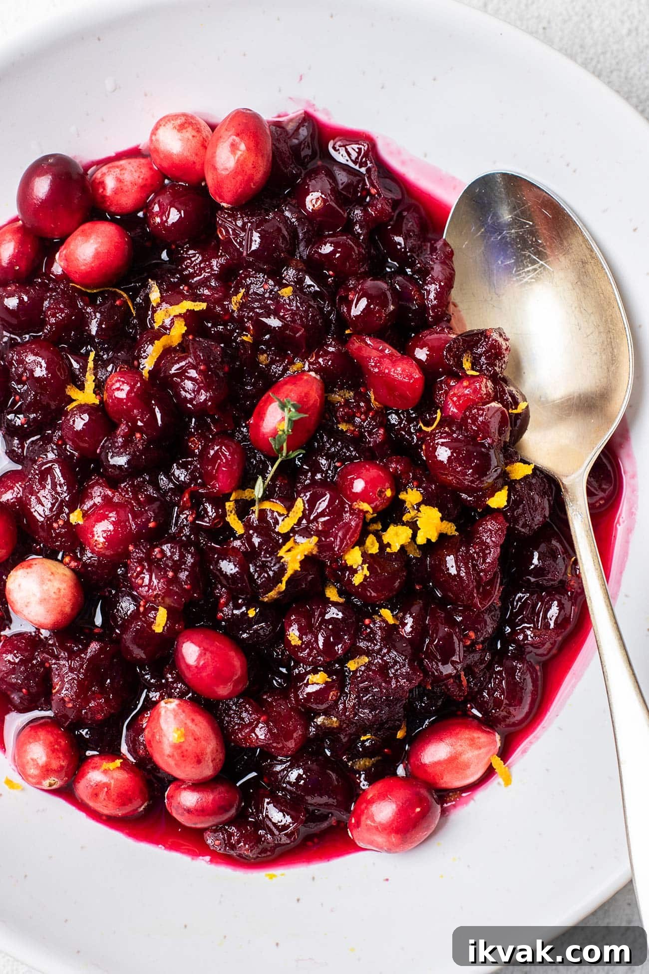 Maple Cranberry Sauce Recipe: Sweet-Tart Holiday Condiment 2 A close up look at fresh cranberry sauce made with maple syrup.