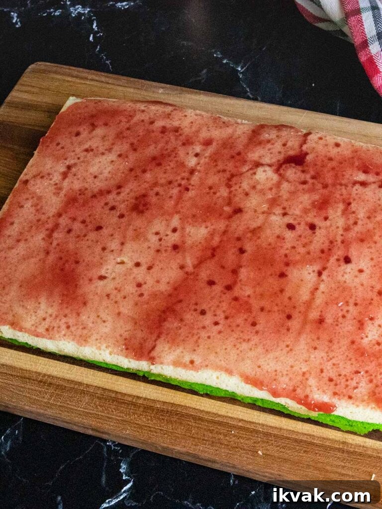 Raspberry jam spread over the white cookie layer.