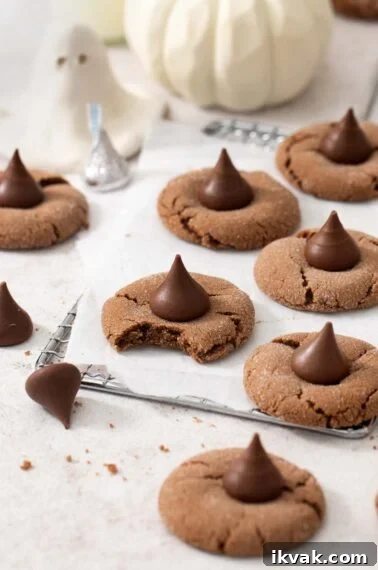 Are Sour Patch Kids Gluten Free? What Ingredients to Know 4 Gluten-free Nutella witch hat cookies on a wire cooling rack. One cookie has a bite taken out of it.