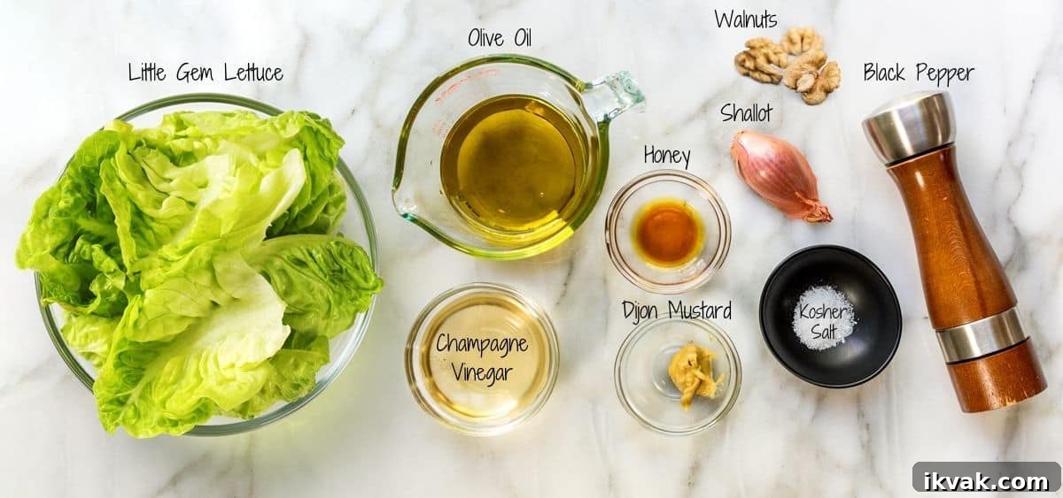 Crisp Little Gem Lettuce Salad with Lemon Vinaigrette 3 Little Gem Salad Ingredients on a white marble board.