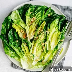 Crisp Little Gem Lettuce Salad with Lemon Vinaigrette 9 Little Gem Salad served on a round white platter and photographed from overhead.