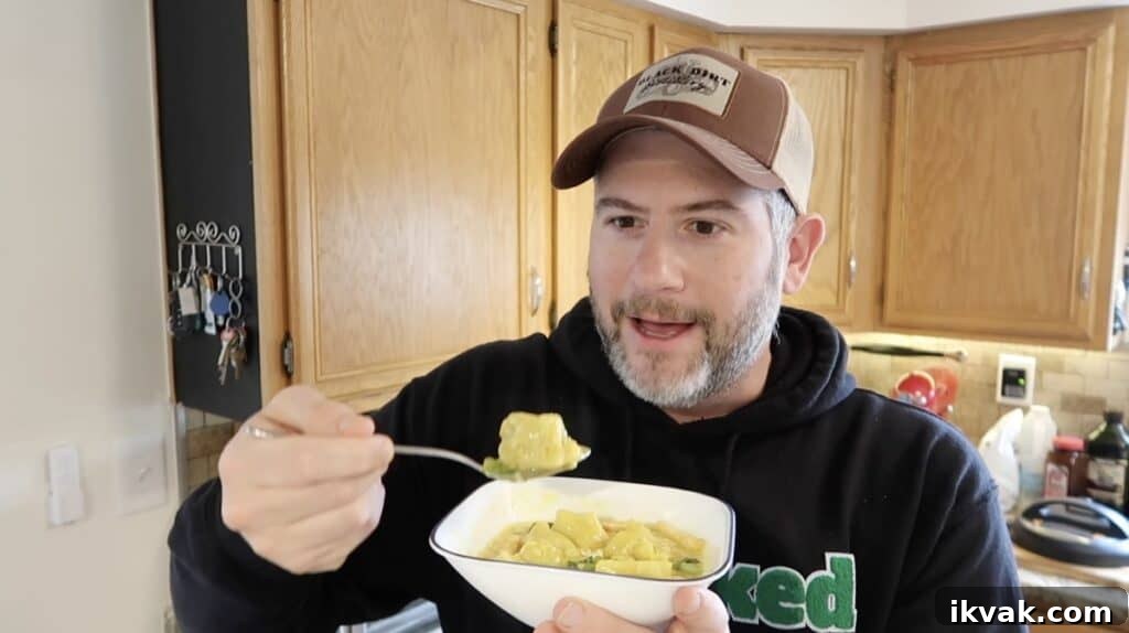 Man with a spoonful of soup looking very excited.