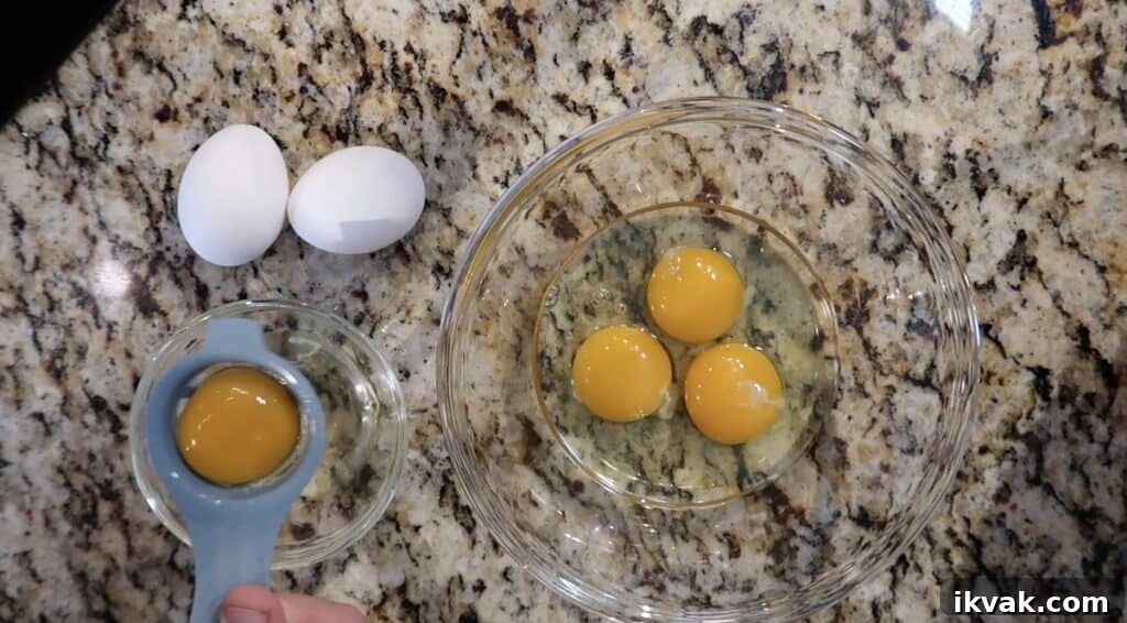 6 eggs: 3 with their egg whites and yolks in a bowl and 3 with just their egg whites being separated from the yolks, with the yolks not being used