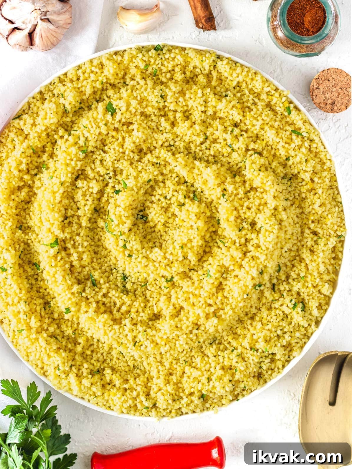 couscous with spices served on a plate with fresh parsley on the side