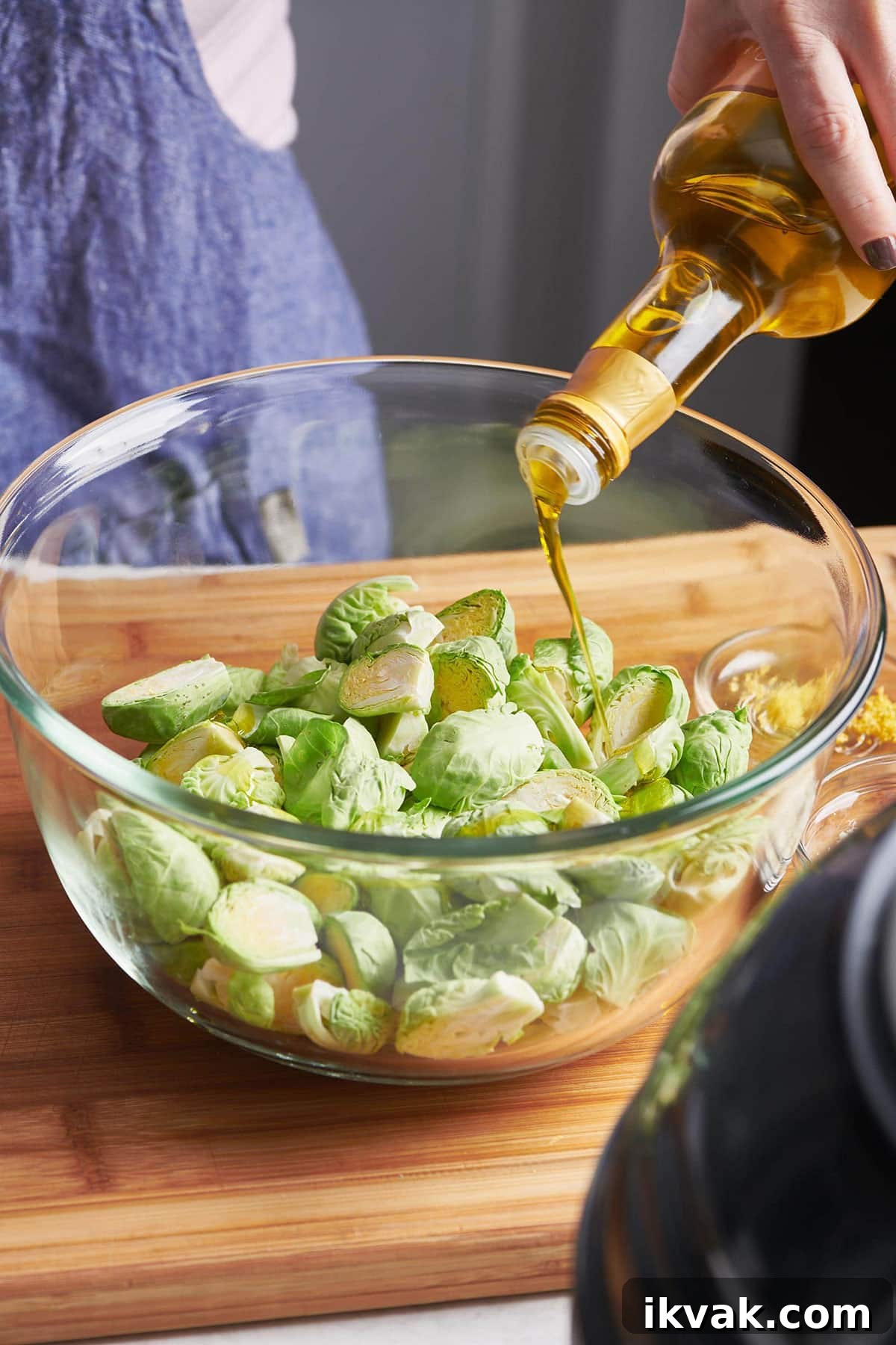 Crispy Roasted Brussels Sprouts: Simple Oven Recipe 2 Pouring oil over Brussels sprouts.
