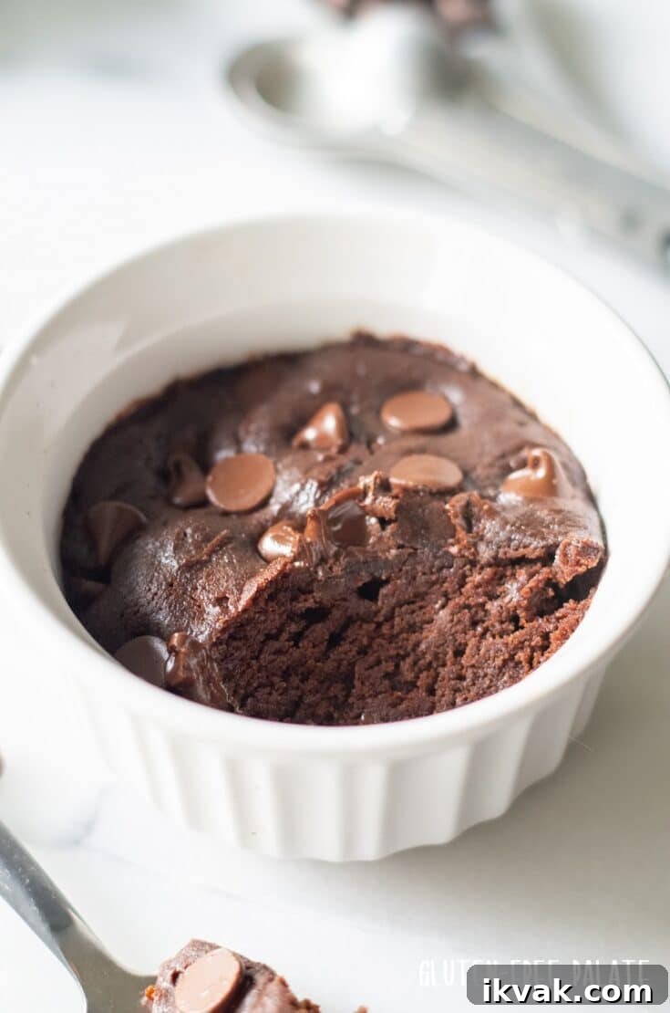 mug cookie in a white ramekin with a bite out