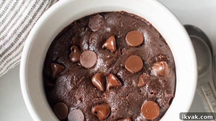 mug cookie in a white ramekin with chocolate chips