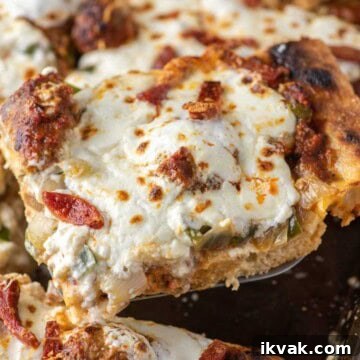 Slice of Sicilian-style pizza being lifted out of sheet pan.
