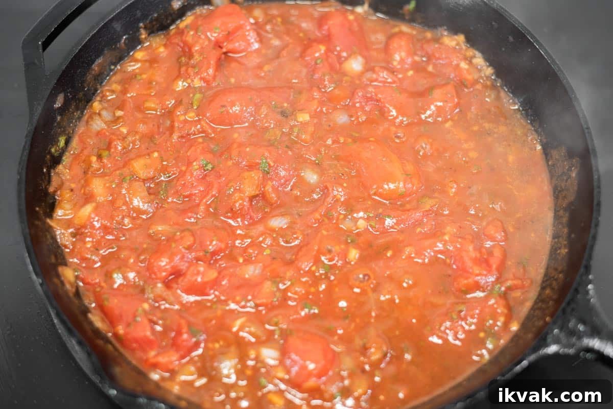 Steak alla Pizzaiola Recipe: Tender Beef in Tomato-Herb Sauce 8 Tomato sauce simmering in skillet.