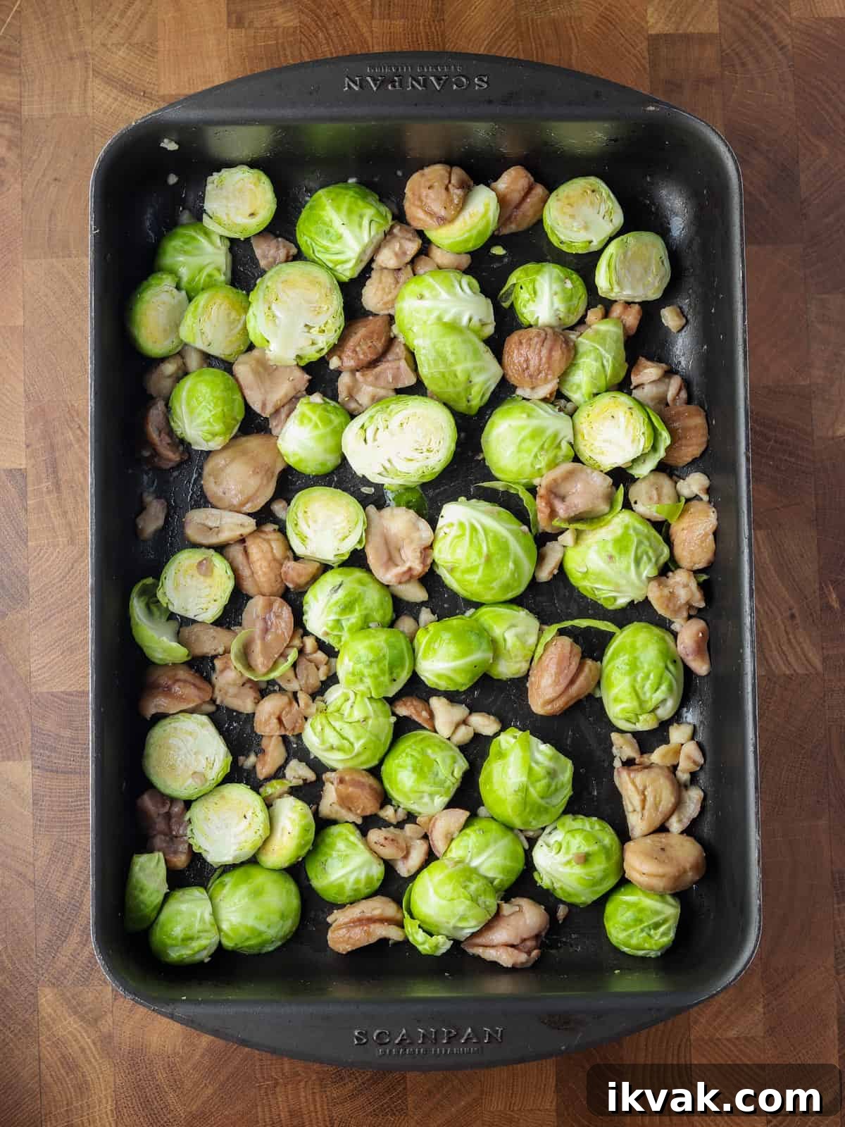Photo of brussles sprouts and chestnuts in a roasting tin ready to roast.