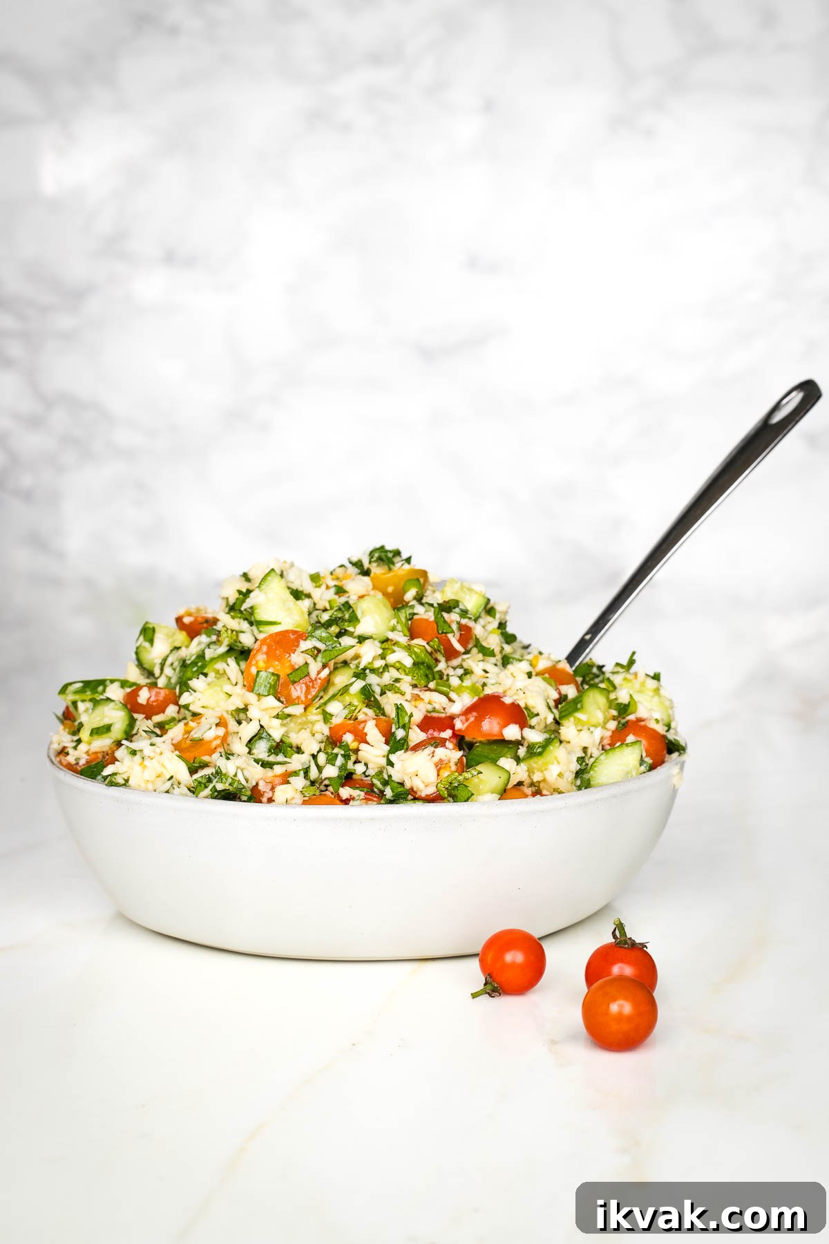 Gluten-Free Tabbouleh with Roasted Parsnips 2 Bowl of colorful tabbouleh with tomatoes, fresh herbs, and scallions.