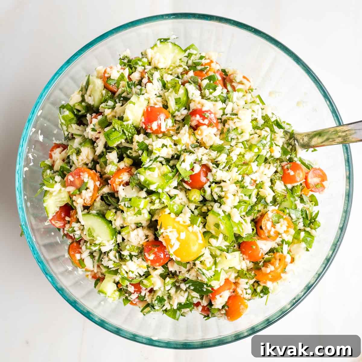 Gluten-Free Tabbouleh with Roasted Parsnips 12 Tabbouleh salad with bright colorful tomatoes, green herbs and cucumbers and little pieces of riced parsnips.