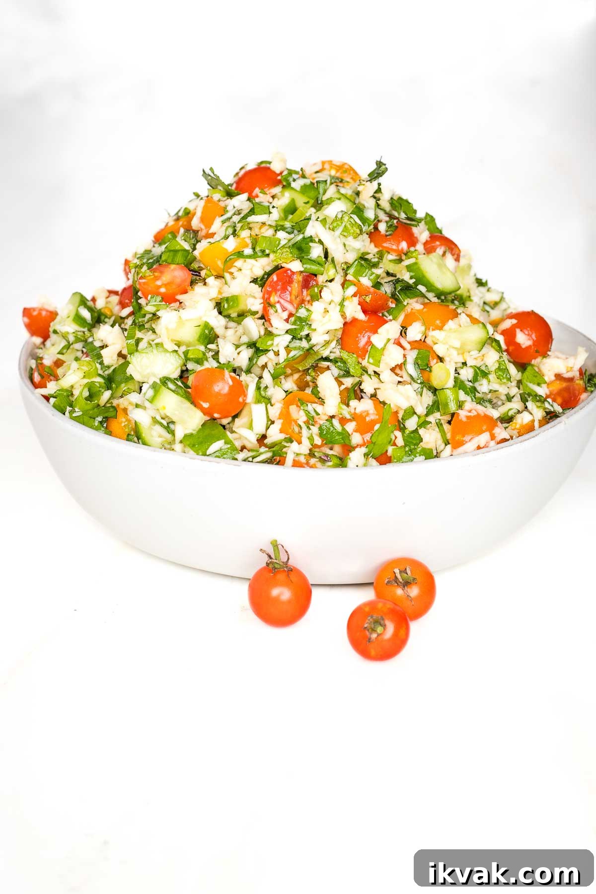 Gluten-Free Tabbouleh with Roasted Parsnips 14 White bowl piled high with tabbouleh that's loaded with fresh tomatoes and cucumbers, lots of fresh herbs, scallions and riced parsnips.