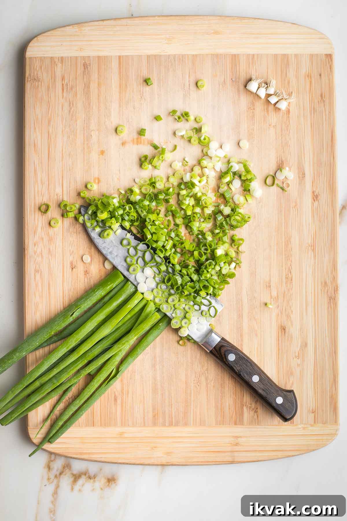 Gluten-Free Tabbouleh with Roasted Parsnips 4 Slicing green onions on a wooden cutting board.