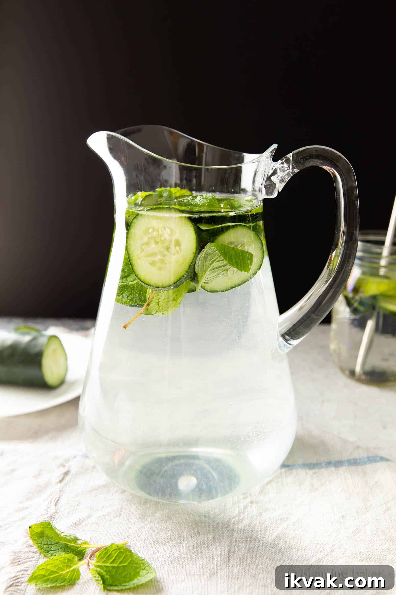 Pitcher of detoxifying beverage against a black backdrop