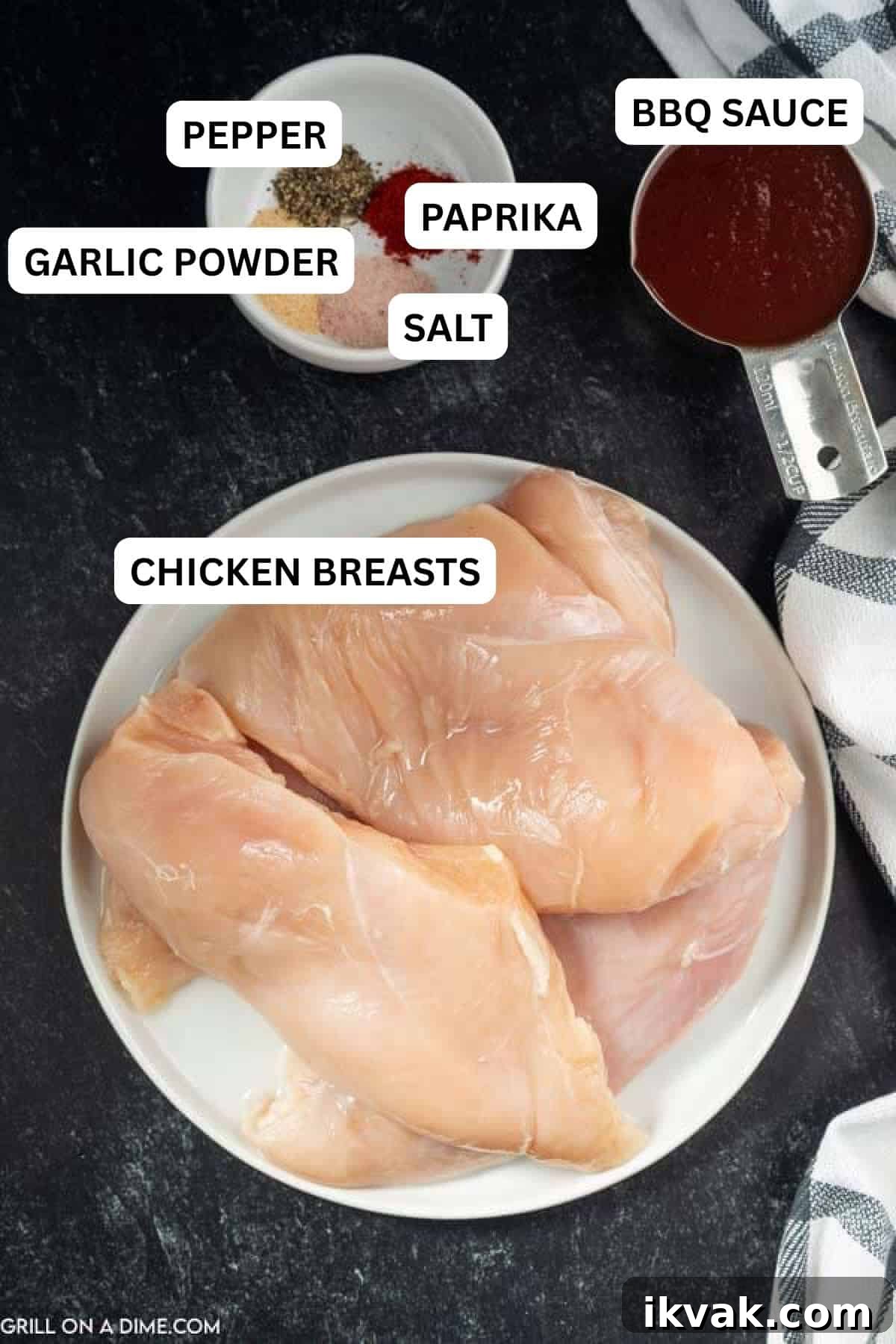 Ingredients need to make this recipe which includes chicken breast on a plate with a measuring cup of BBQ Sauce and a bowl of spices.