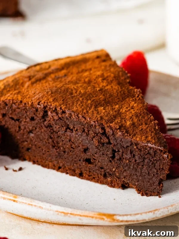 A slice of torta caprese on a white plate.