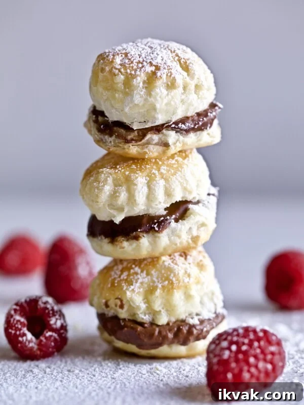 Chocolate cream puffs with raspberries.