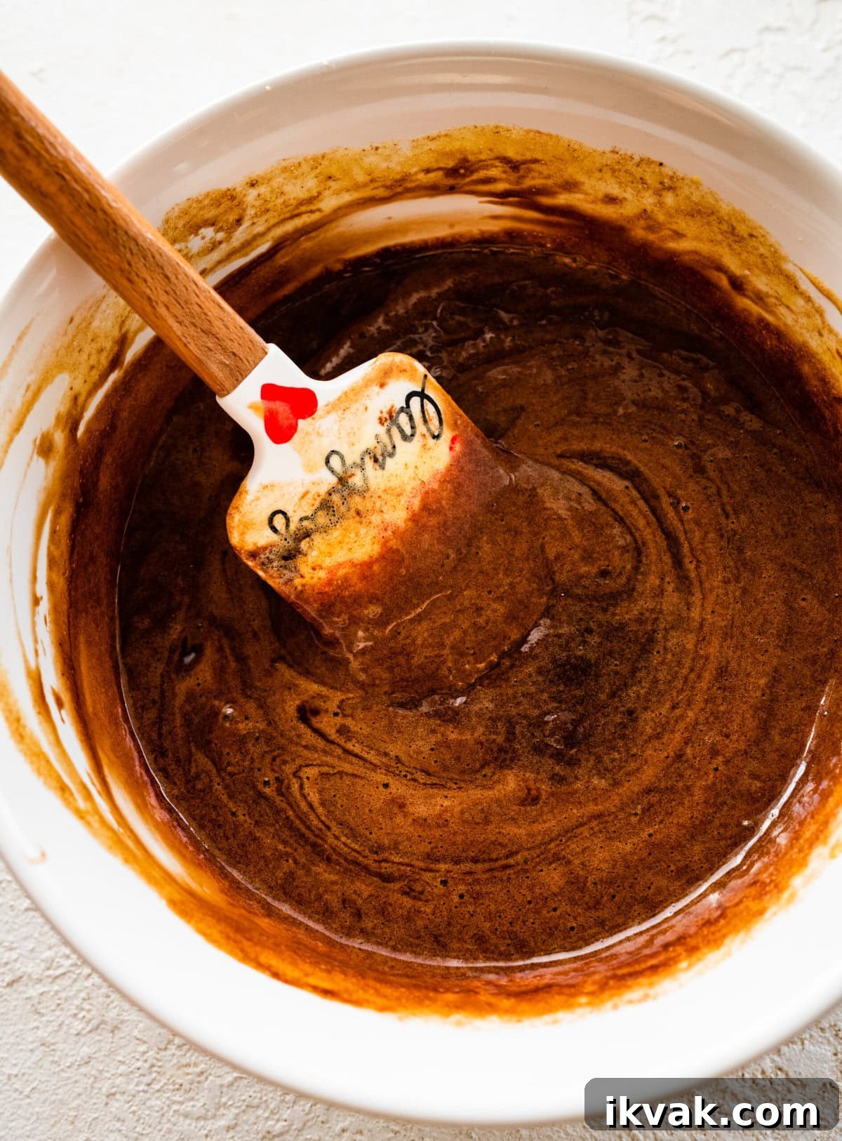 Folding melted chocolate into egg mixture.