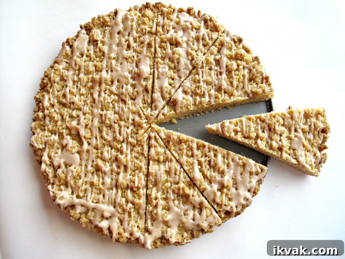 Cinnamon Streusel Cookie Recipe: Crispy, Buttery Bites 6 Streusel Cookies baked in a cake pan, drizzled with icing and sliced into wedges.