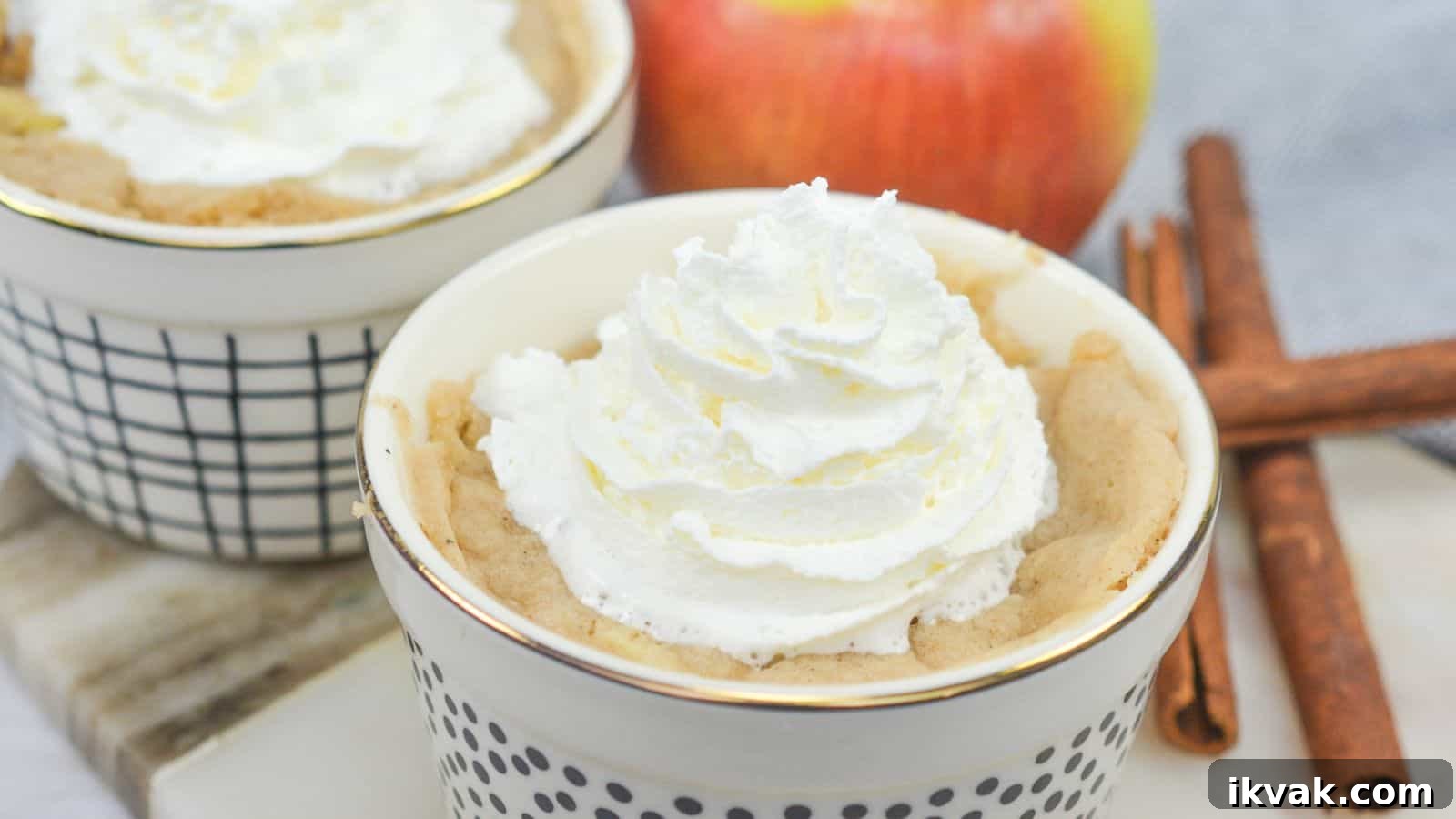 11 Mess-Free Mug Cake Recipes for Quick Single-Serve Desserts 9 Apple mug cakes in ramekins with cinnamon sticks.