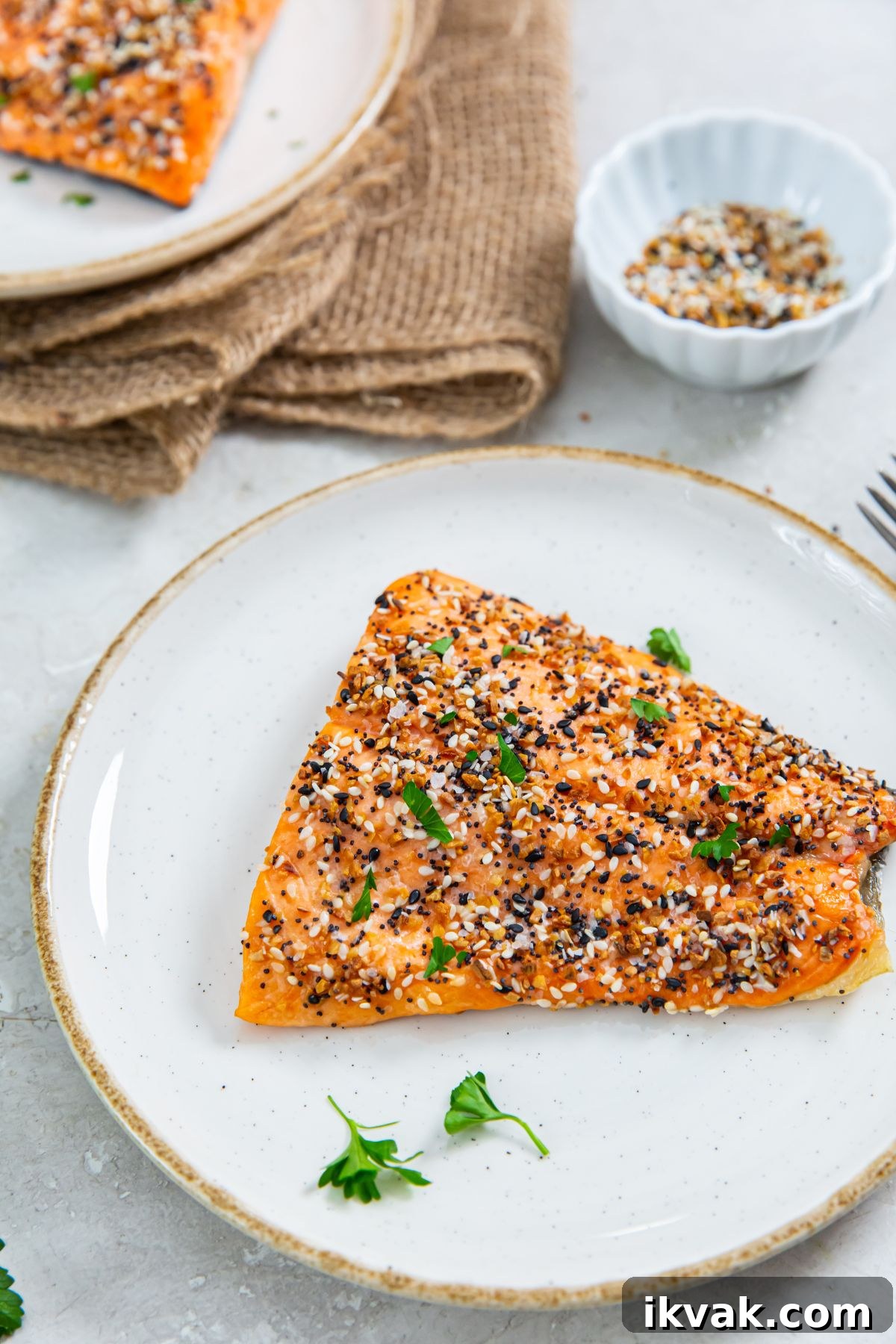 air fryer everything bagel salmon on a white plate with a side of vegetables