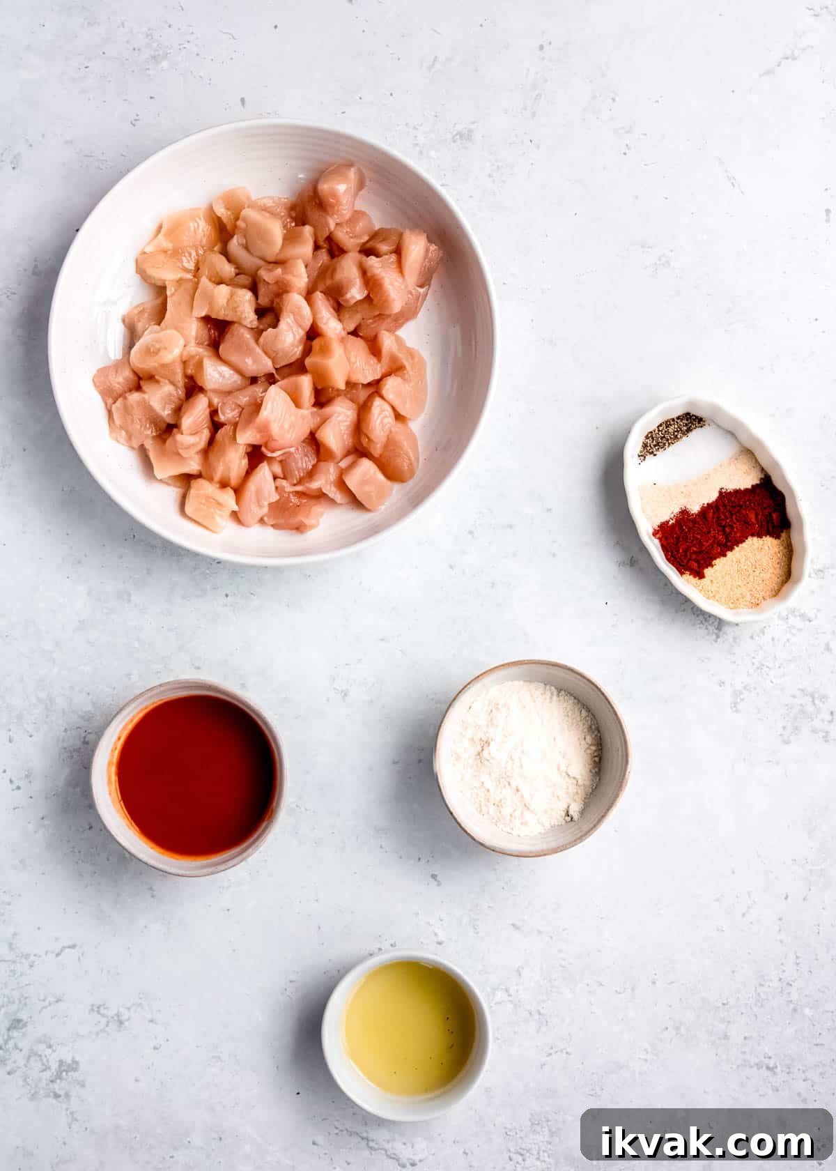 Crispy Air Fryer Buffalo Chicken Bites with Blue Cheese Dip 3 buffalo chicken bite ingredients on a white table