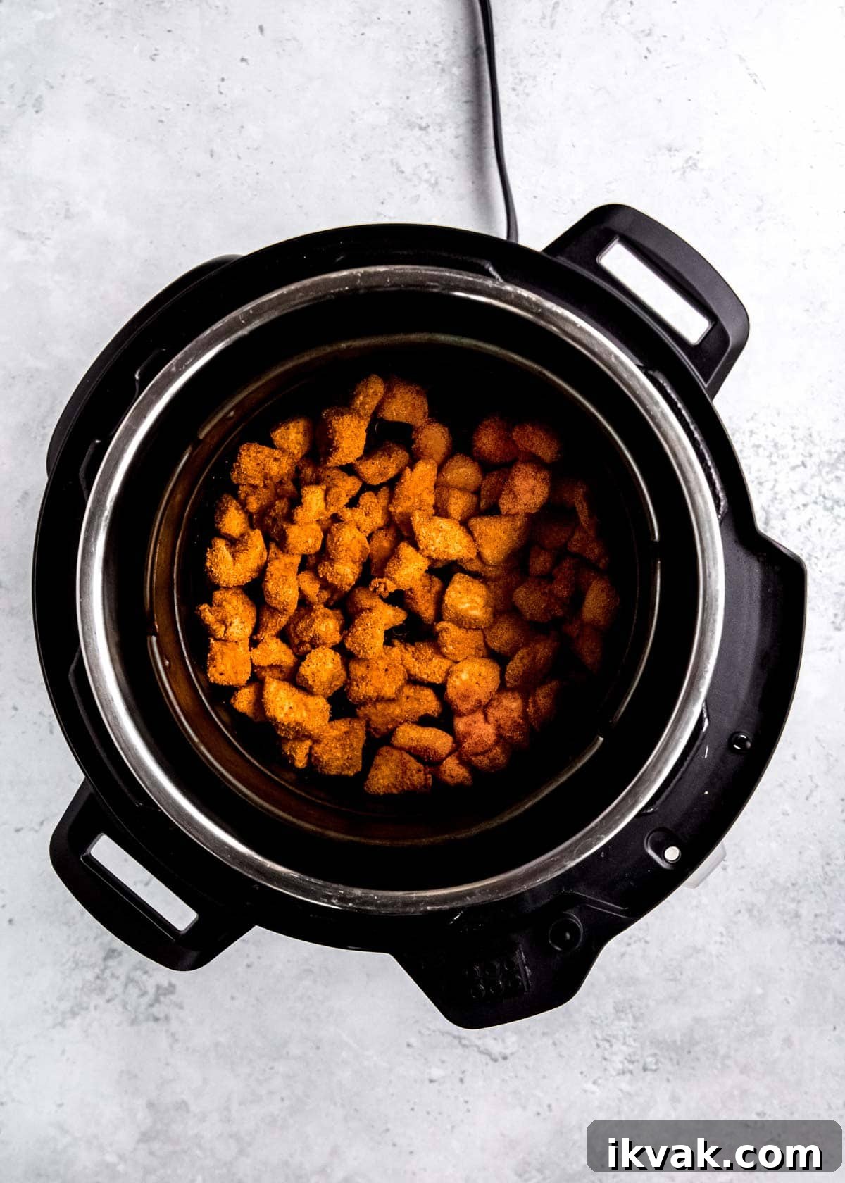 Crispy Air Fryer Buffalo Chicken Bites with Blue Cheese Dip 6 seasoned chicken bites in black slow cooker