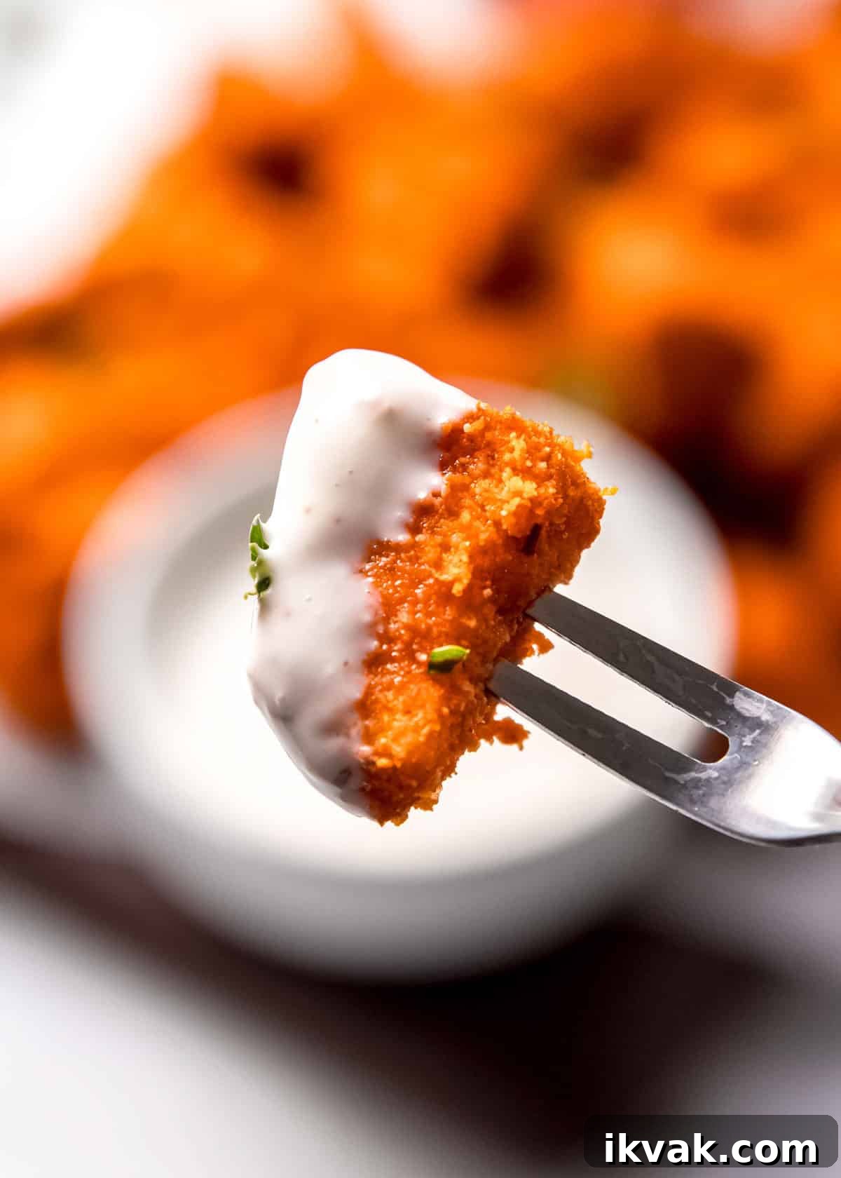 Crispy Air Fryer Buffalo Chicken Bites with Blue Cheese Dip 8 close up of buffalo chicken bite dipped in ranch dressing