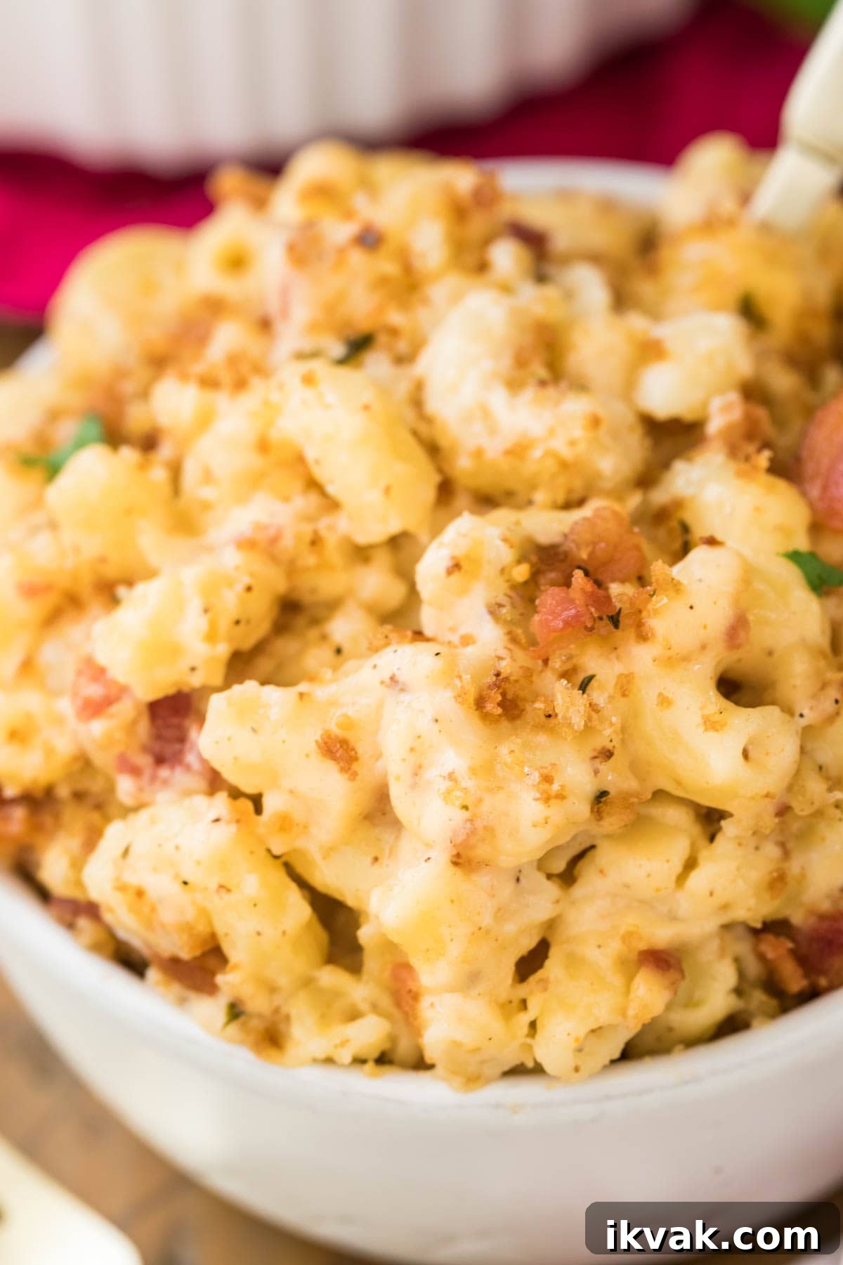 zoomed in view of bowl full of bacon mac and cheese topped with crispy bacon and panko