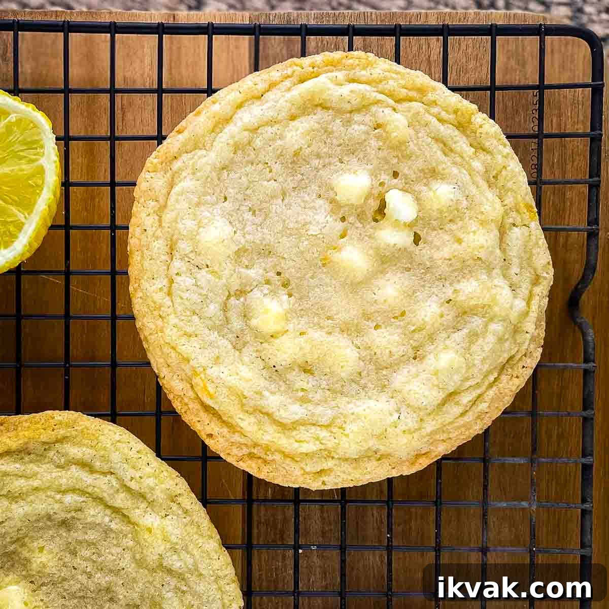 Lemon Drop Cookies Recipe: Soft, Chewy Cookies Like Panera 12 A large lemon white chocolate chip cookie in a cooling rack.