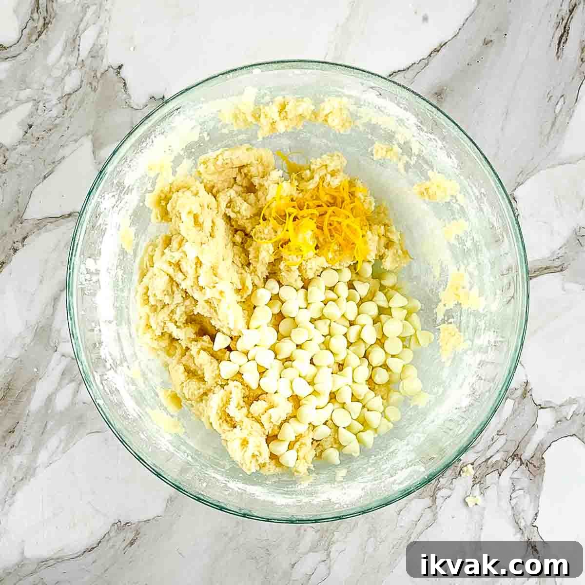 Lemon Drop Cookies Recipe: Soft, Chewy Cookies Like Panera 7 The ingredients combined in a glass mixing bowl, with the lemon zest and white chocolate chips added.