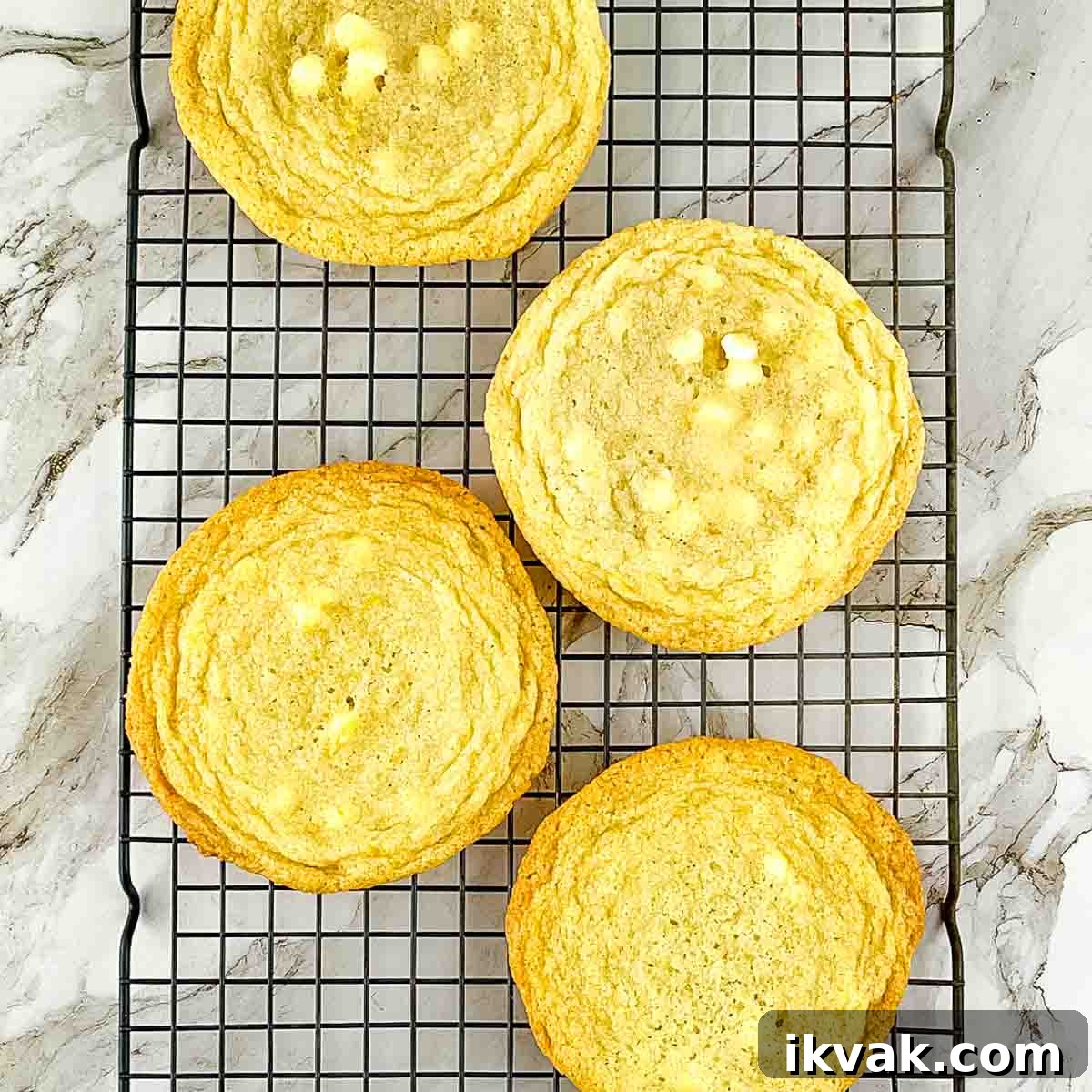 Lemon Drop Cookies Recipe: Soft, Chewy Cookies Like Panera 10 Freshly baked lemon white chocolate chip cookies cooling on a wire rack.