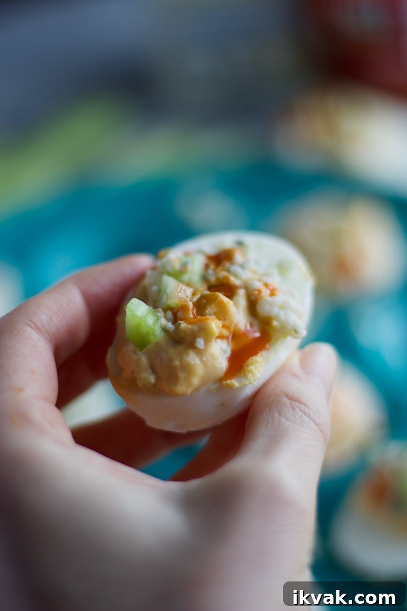 Spicy Buffalo Deviled Eggs with Blue Cheese 12 Buffalo Deviled Eggs - a kicked up deviled egg, featuring blue cheese, celery, and of course, hot sauce! | fedandfulfilled.com