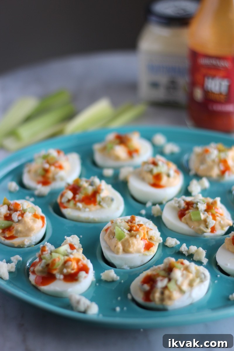 Buffalo Deviled Eggs - creamy deviled egg filling is combined with celery, blue cheese, and hot sauce for a spin on a classic. YUM. | fedandfulfilled.com