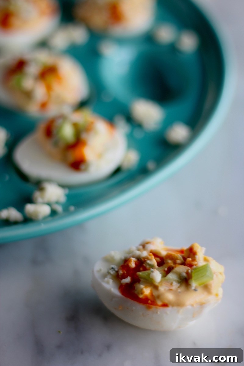 Buffalo Deviled Eggs - creamy deviled egg filling is loaded with blue cheese, hot sauce, and celery to create a colorful, flavorful take on a classic! | fedandfulfilled.com