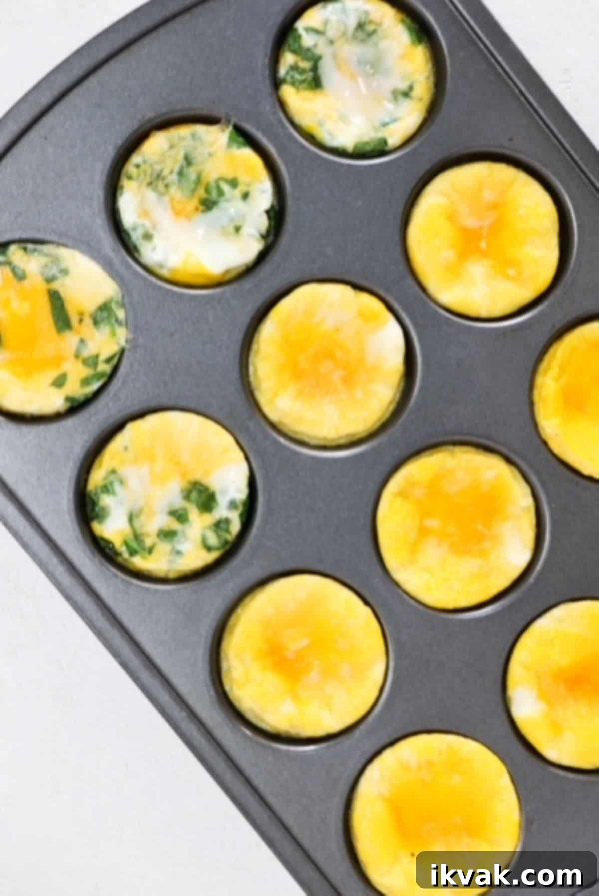 Baked eggs in a muffin tin, some plain and some with spinach and cheese.
