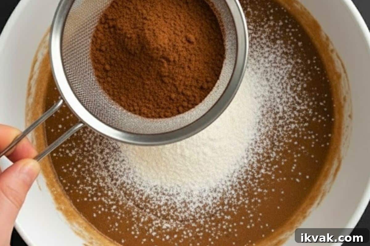 Sift the flour and cocoa powder directly into the wet mixture.