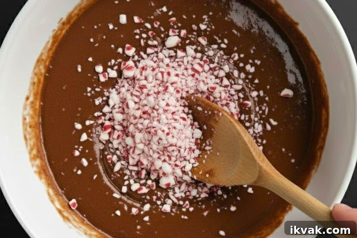 Add most of the candy canes into the batter and carefully fold them.