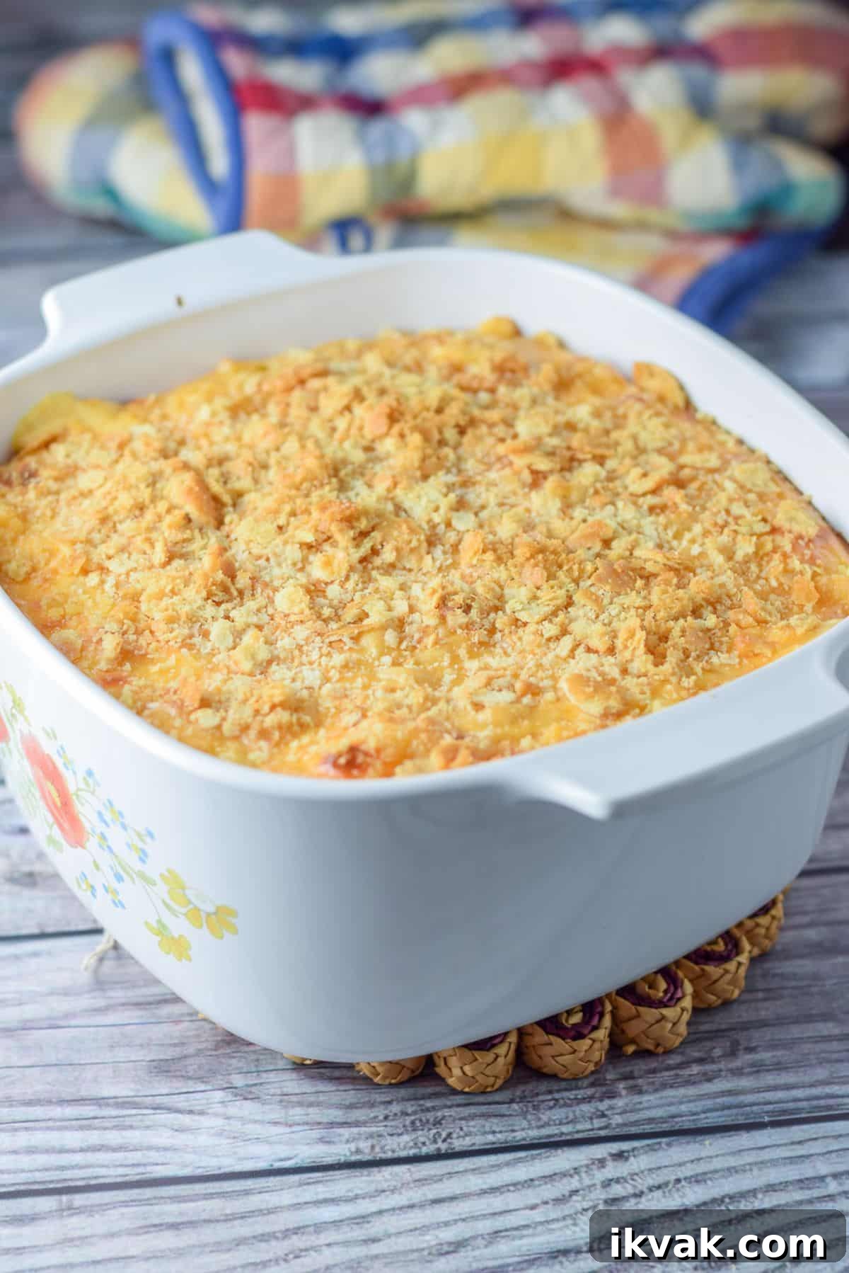 Ultimate Creamy Baked Mac and Cheese Recipe 7 A casserole dish with ritz crackers sprinkled on mac and cheese and straight out of the oven