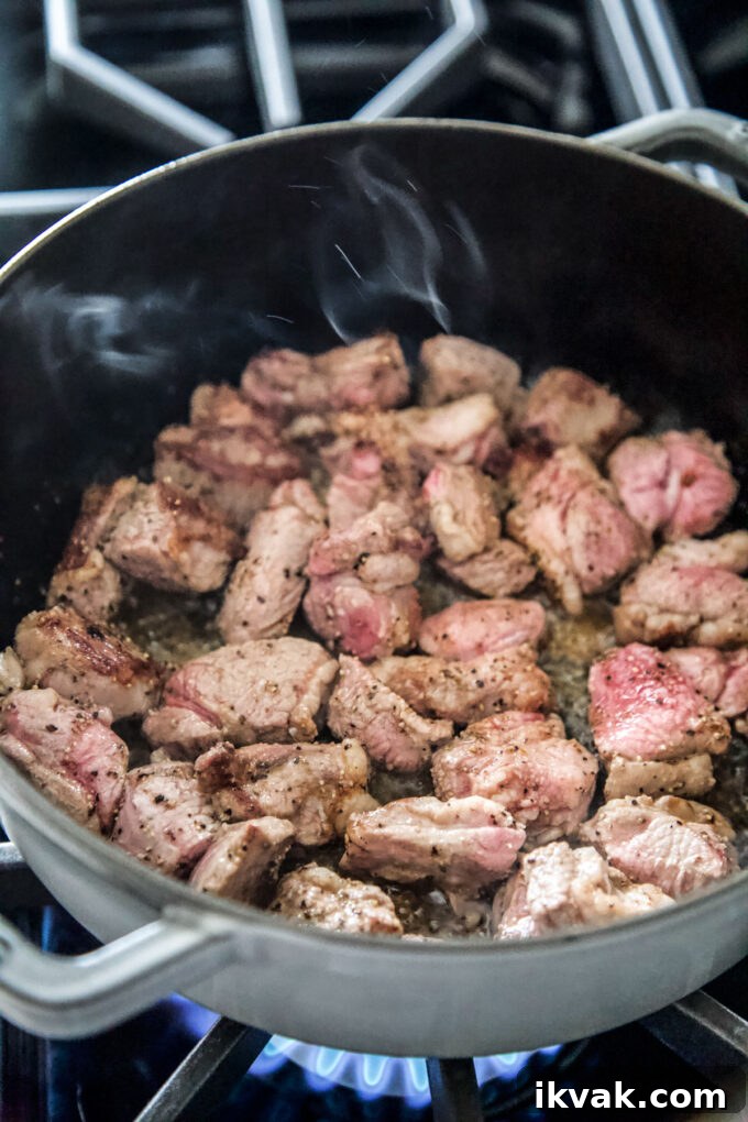 lamb shoulder simmering in a pot