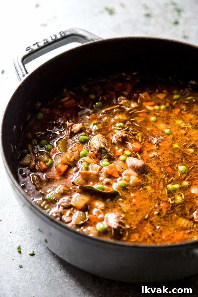 lamb shoulder simmering in a pot 