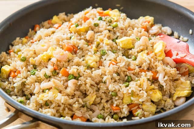 Fried Rice Recipe - Served In a Nonstick Skillet with Egg, Carrots, and Peas