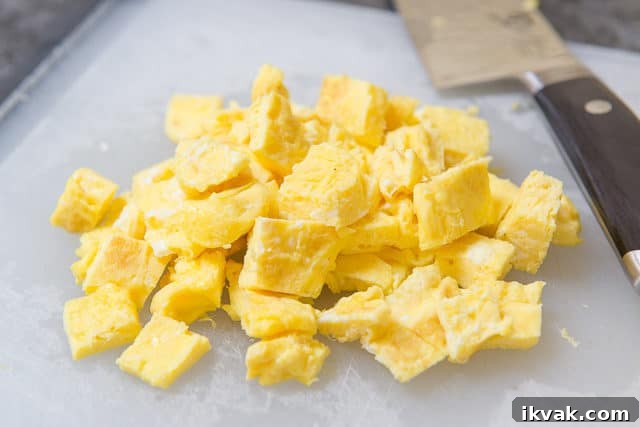 Chopped Pieces of Egg on Cutting Board