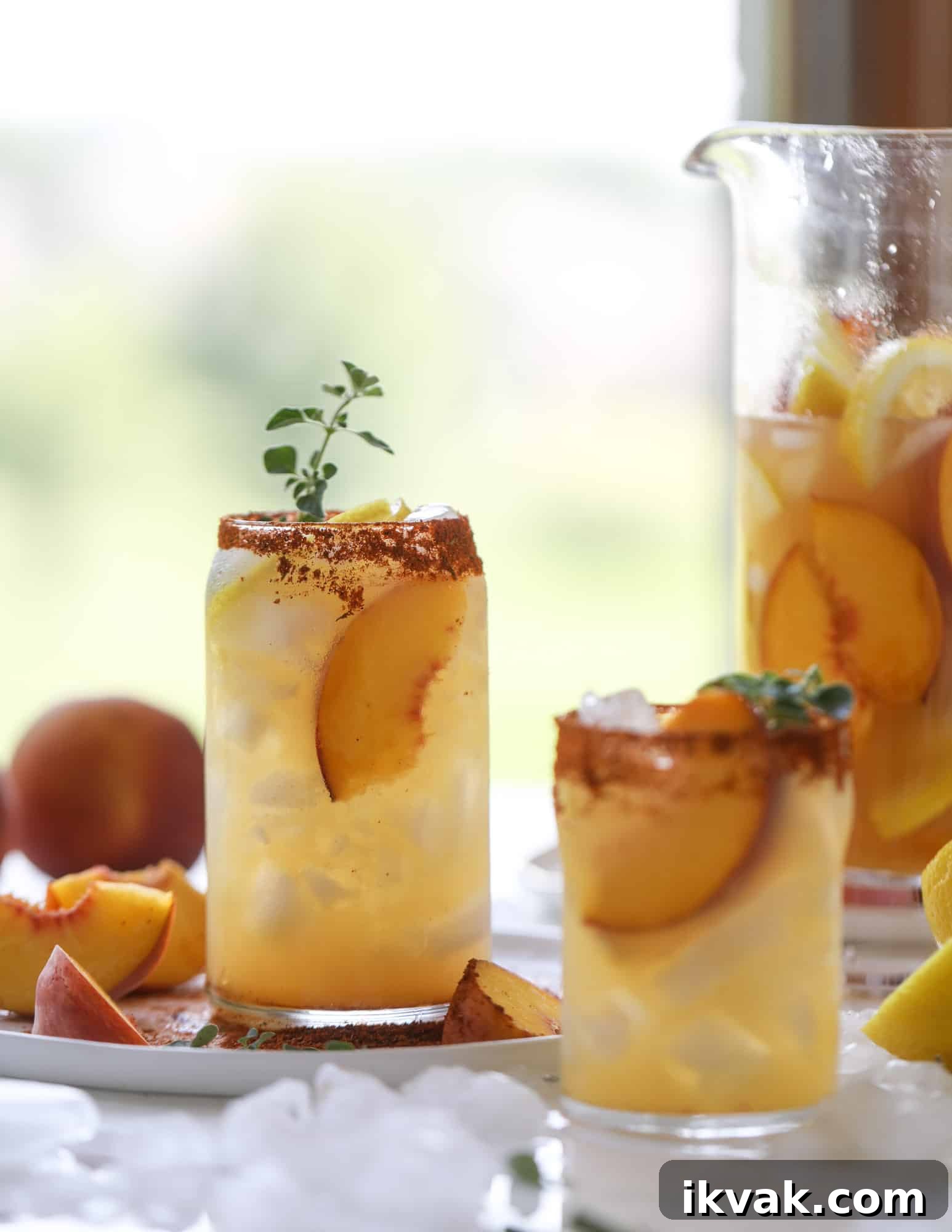 This peach lemonade is super refreshing and a bit spicy for a hot and sunny summer day. It's sweet and fresh and the rim is dipped in a cajun seasoning, bringing the best bite of heat to this perfect summer drink. So fresh! I howsweeteats.com #peach #lemonade #cajun #summer #mocktail #lemon #drink