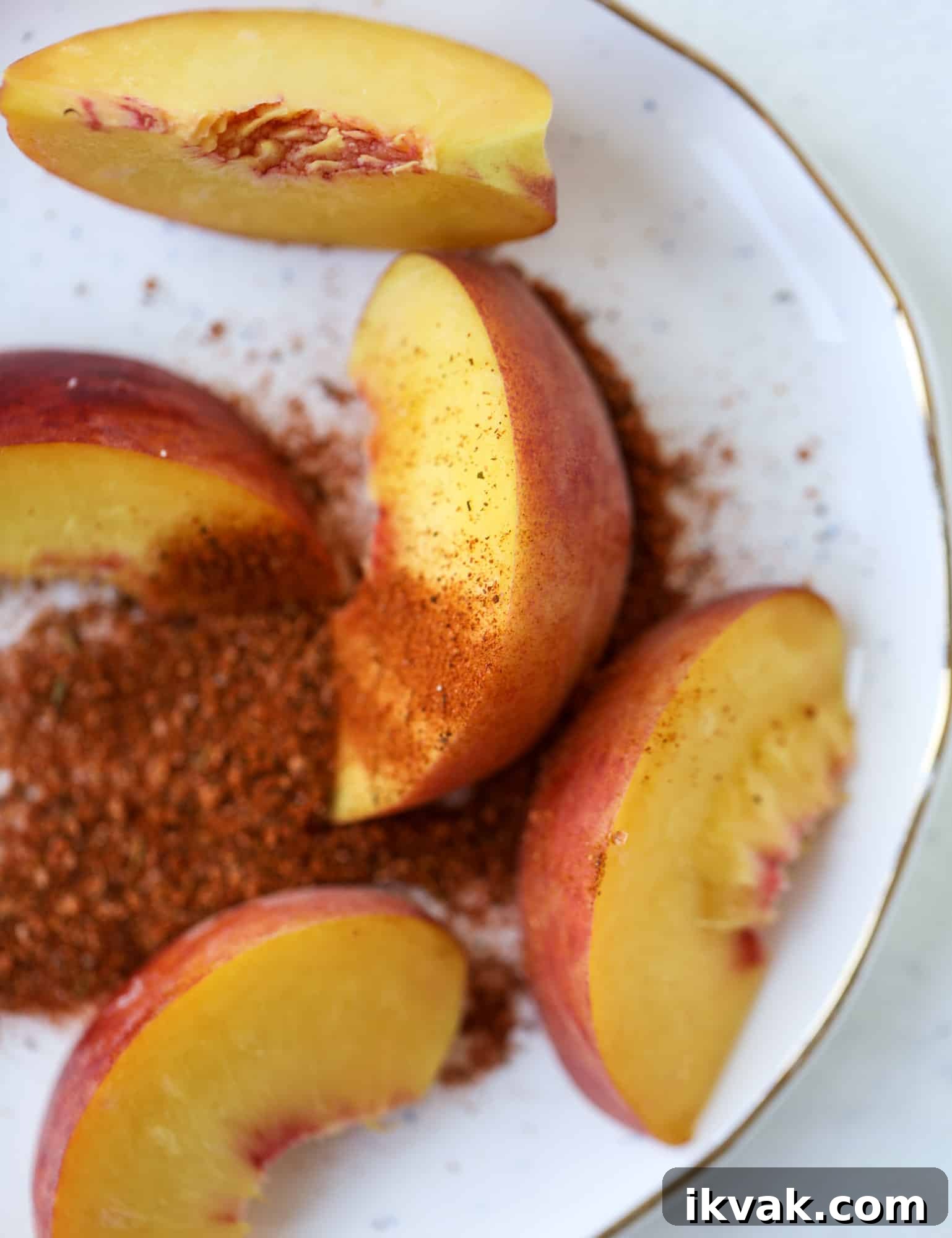 This peach lemonade is super refreshing and a bit spicy for a hot and sunny summer day. It's sweet and fresh and the rim is dipped in a cajun seasoning, bringing the best bite of heat to this perfect summer drink. So fresh! I howsweeteats.com #peach #lemonade #cajun #summer #mocktail #lemon #drink